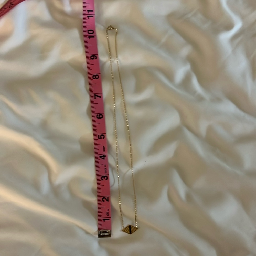 Gold chain necklace with diamond shaped charm detail